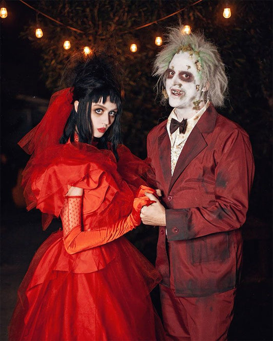 Halloween Couples Costume: Beetlejuice and Lydia from the Beetle Juice movie. Lydia is wearing her red wedding dress and Beetlejuice his red tux.