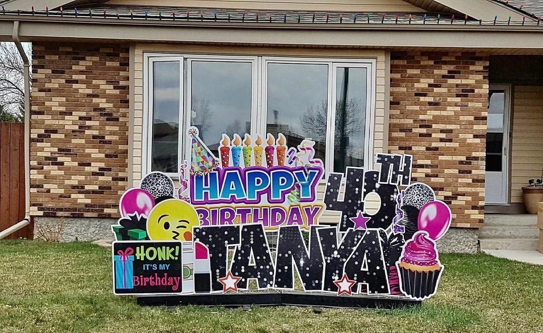 A yard card greeting in front of someone's home that reads "Happy 40th Birthday Tanya" and "Honk! It's my birthday".